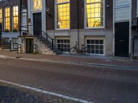 the reflection of a building on the street has been captured by the street light of the bike in the window