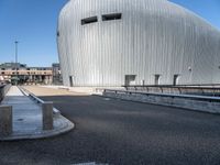 a building has an unusual design, with windows, a dome and a small fountain in the street