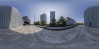 360 degree lens photo of a city view and a skateboarder in the foreground