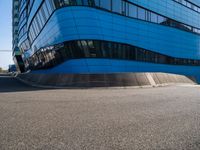 a skateboarder is going down the street past a tall building that has been turned into a tower