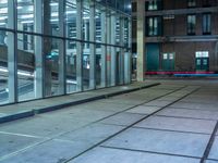 empty street with glass and metal buildings in the background and on the other side a bike parking lot