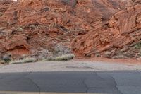 the woman is standing on a stop sign in front of a large canyon in nevada