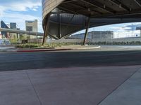 an outside street and some building in the background with a curve in it that is red and black,