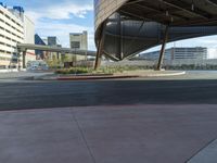 an outside street and some building in the background with a curve in it that is red and black,