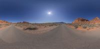 a fisheye lens photo of the desert under blue skies and stars in a sunny day