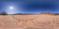 a panoramic view of the landscape in a desert area with tracks and rocks