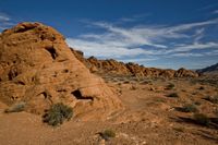 rocks and a dirt ground on a sunny day with blue sky in the background, a trail through