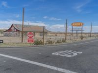 the sign of route 66 in the deserted town of texas, with road and vacant business