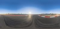 the view through a fisheye lens lens of a track at a racetrack in nevada