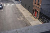 the view down the street from a building in brooklyn new york city on a sunny day