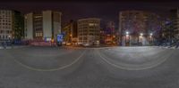 an image taken from inside of a street view with a circular view of buildings at night