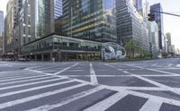 a stoplight near a large art piece on a city street corner in new york