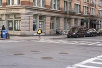the person is crossing the street at this crosswalk intersection to get there car to be seen
