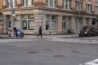 the person is crossing the street at this crosswalk intersection to get there car to be seen