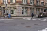 the person is crossing the street at this crosswalk intersection to get there car to be seen