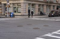 the person is crossing the street at this crosswalk intersection to get there car to be seen