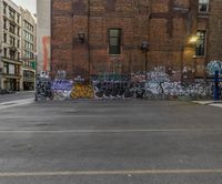 this photo has a lot of graffiti on the side of it and has many windows