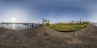 a fisheye view shows the view of buildings on the side of a riverbank