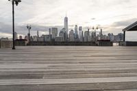 the skyline is visible in the background from the pier in lower manhattan, new york
