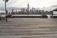 the skyline is visible in the background from the pier in lower manhattan, new york