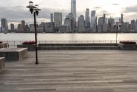 the skyline is visible in the background from the pier in lower manhattan, new york