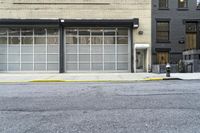 a fire hydrant is set in the middle of an empty street next to a tall building