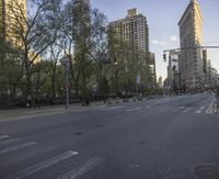 a city street that has been completely deserted since the sun is set in the background