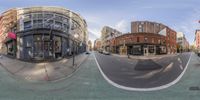 a street with buildings and a motorcycle is shown through the 360 - lens of an upside down view