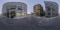 a 360 - view image of a street with building on the left and an intersection that is in a circle