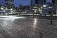 a view of new york city skyline at night from pier on the hudson river side