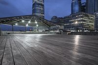 a view of new york city skyline at night from pier on the hudson river side