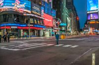 a busy city with pedestrians walking through the street at night time in times square, new york city