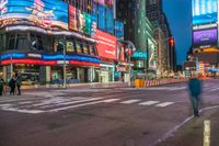 a busy city with pedestrians walking through the street at night time in times square, new york city