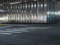 a building is behind the street in front of it and a man crossing the road