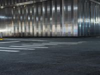 a building is behind the street in front of it and a man crossing the road