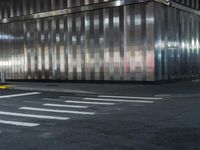 a building is behind the street in front of it and a man crossing the road