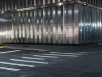 a building is behind the street in front of it and a man crossing the road