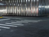 a building is behind the street in front of it and a man crossing the road