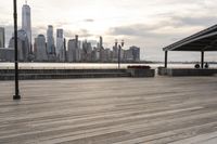 the skyline is visible in the background from the pier in lower manhattan, new york