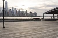 the skyline is visible in the background from the pier in lower manhattan, new york