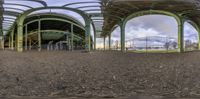 a view through a panoramic lens of a barn with animals in the pen