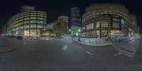 a night view of a city street taken in a 360 - angle view lens while it is still busy