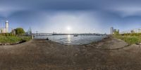 fish eye image of large city skyline with dock and pier in foreground at sunset