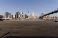 a view of city skyline and the water and bridge in lower town of new york