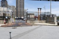 the empty urban street has some metal structures on the side of it, including a fire hydrant and manholed access
