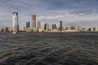 the large body of water that is close to the shore area with city buildings in the distance