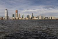 the large body of water that is close to the shore area with city buildings in the distance