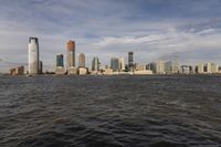 the large body of water that is close to the shore area with city buildings in the distance
