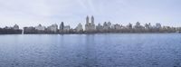 an image of the city skyline across a large river in central park, new york city
