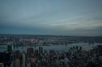 the skylines and city lights are reflected in the water from above the building, which looks like a heart shaped arrow